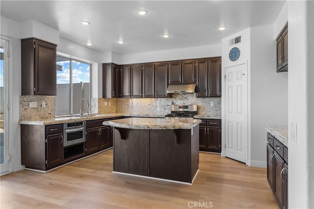 8840 Greenlawn St, Riverside, CA 92508 - kitchen with appliances with stainless steel finishes, a sink, tasteful backsplash, light wood-type flooring, and recessed lighting
