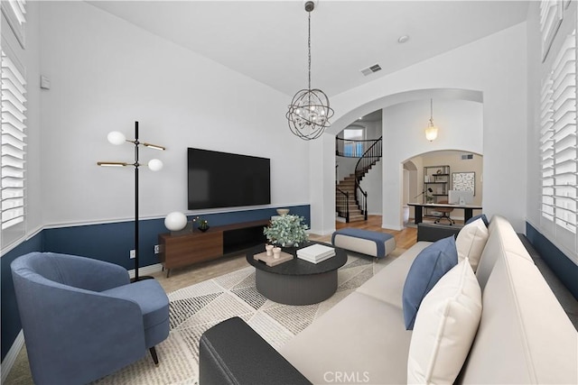 8840 Greenlawn St, Riverside, CA 92508 - living room with stairway, arched walkways, healthy amount of natural light, and a chandelier