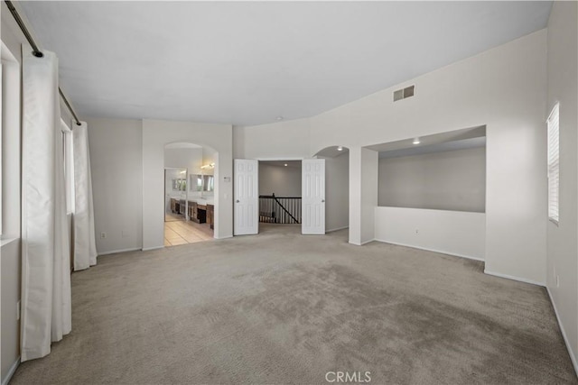 8840 Greenlawn St, Riverside, CA 92508 - unfurnished bedroom with arched walkways, carpet floors, baseboards, and connected bathroom