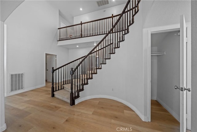 8840 Greenlawn St, Riverside, CA 92508 - stairs featuring wood finished floors, arched walkways, baseboards, a high ceiling, and recessed lighting
