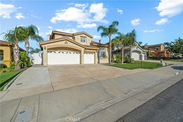 8840 Greenlawn St, Riverside, CA 92508 - mediterranean / spanish house with stucco siding, a front yard, a tiled roof, concrete driveway, and a gate