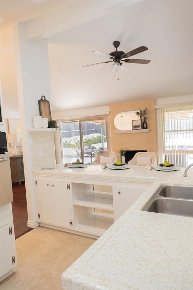 5283 Chollas Pkwy, San Diego, CA 92105 - kitchen with a sink, open shelves, ceiling fan, white cabinetry, and light tile patterned flooring