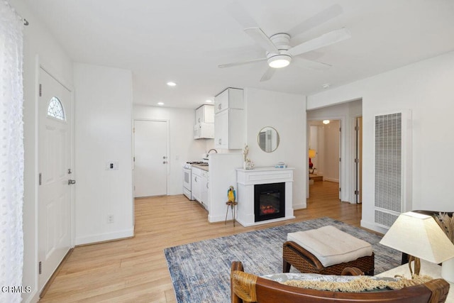 3701 Sunset Ln, Oxnard, CA 93035 - living room with a heating unit, light wood-style flooring, a ceiling fan, baseboards, and recessed lighting
