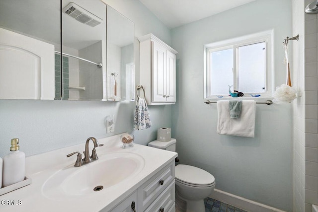 3701 Sunset Ln, Oxnard, CA 93035 - bathroom with toilet, vanity, tiled shower, and baseboards