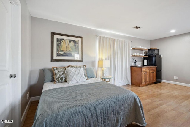 3701 Sunset Ln, Oxnard, CA 93035 - bedroom with light wood-style flooring, baseboards, freestanding refrigerator, and recessed lighting
