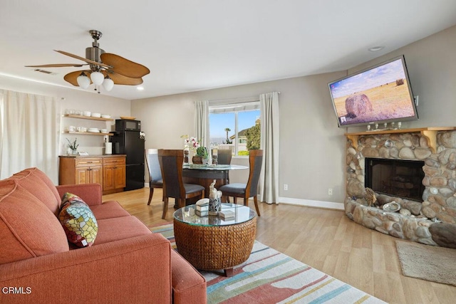 3701 Sunset Ln, Oxnard, CA 93035 - living area with light wood-style flooring, baseboards, a stone fireplace, ceiling fan, and recessed lighting