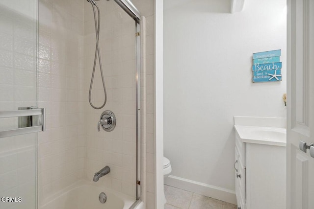3701 Sunset Ln, Oxnard, CA 93035 - bathroom with washtub / shower combination, toilet, vanity, tile patterned floors, and baseboards