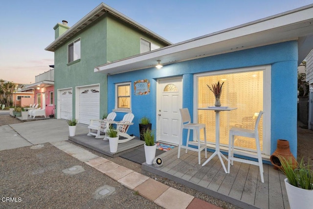 3701 Sunset Ln, Oxnard, CA 93035 - view of front of home with a chimney, a garage, concrete driveway, and stucco siding