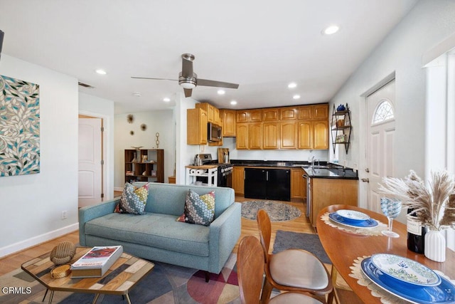 3701 Sunset Ln, Oxnard, CA 93035 - kitchen featuring stainless steel appliances, dark countertops, light wood finished floors, recessed lighting, and ceiling fan