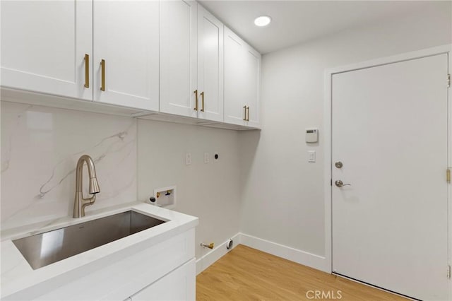 7848 Calmcrest Dr, Downey, CA 90240 - laundry room featuring cabinet space, washer hookup, hookup for an electric dryer, light wood-style floors, and baseboards