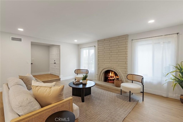7848 Calmcrest Dr, Downey, CA 90240 - living room with light wood-style flooring, recessed lighting, baseboards, and a fireplace