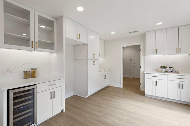 7848 Calmcrest Dr, Downey, CA 90240 - kitchen with beverage cooler, light countertops, glass insert cabinets, baseboards, and recessed lighting