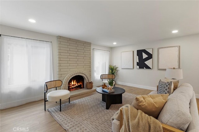 7848 Calmcrest Dr, Downey, CA 90240 - living room with light wood-style flooring, baseboards, recessed lighting, and a fireplace