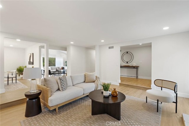 7848 Calmcrest Dr, Downey, CA 90240 - living room with light wood-type flooring, recessed lighting, and baseboards