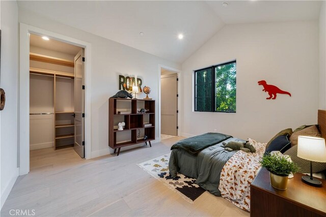 4634 Vesper Ave, Sherman Oaks, CA 91403 - bedroom featuring a walk in closet, vaulted ceiling, recessed lighting, light wood-style flooring, and a closet
