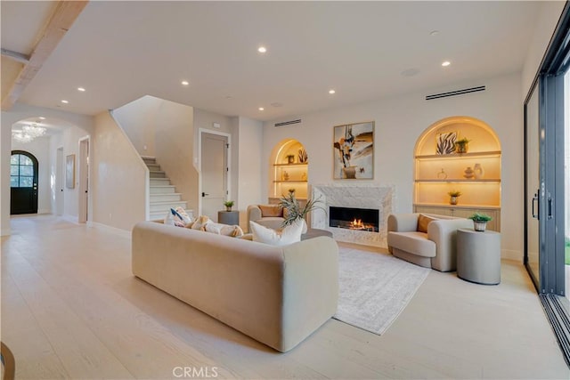 4634 Vesper Ave, Sherman Oaks, CA 91403 - living area with arched walkways, stairs, recessed lighting, a high end fireplace, and built in shelves