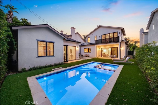 4634 Vesper Ave, Sherman Oaks, CA 91403 - back of property with a balcony, stucco siding, a lawn, and a patio