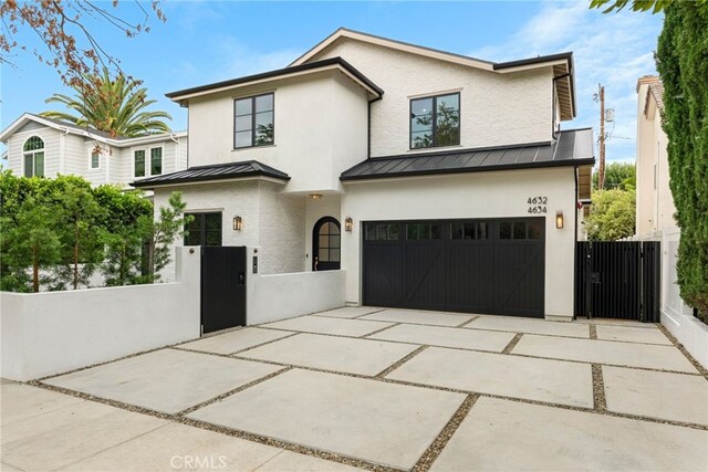 4634 Vesper Ave, Sherman Oaks, CA 91403 - view of front of home with a standing seam roof, a gate, a fenced front yard, a garage, and driveway