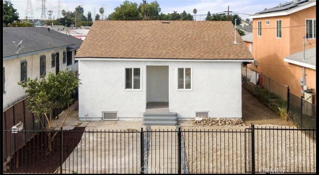 8917 Bandera St, Los Angeles, CA 90002 - rear view of property featuring a shingled roof and stucco siding