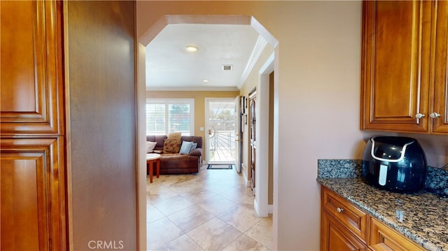 14862 Temple Ave, La Puente, CA 91744 - corridor with arched walkways, ornamental molding, light tile patterned floors, and baseboards