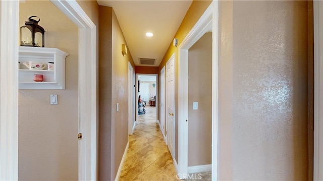 14862 Temple Ave, La Puente, CA 91744 - corridor featuring light tile patterned floors, a textured wall, and baseboards