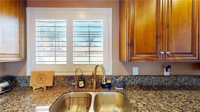 14862 Temple Ave, La Puente, CA 91744 - kitchen view of a sink, dark stone countertops, and brown cabinets