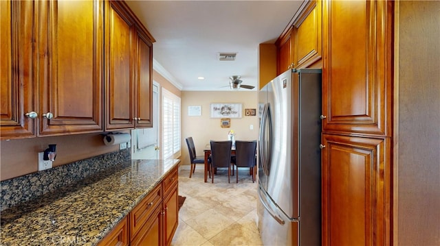 14862 Temple Ave, La Puente, CA 91744 - kitchen featuring freestanding refrigerator, a ceiling fan, ornamental molding, dark stone countertops, and brown cabinetry