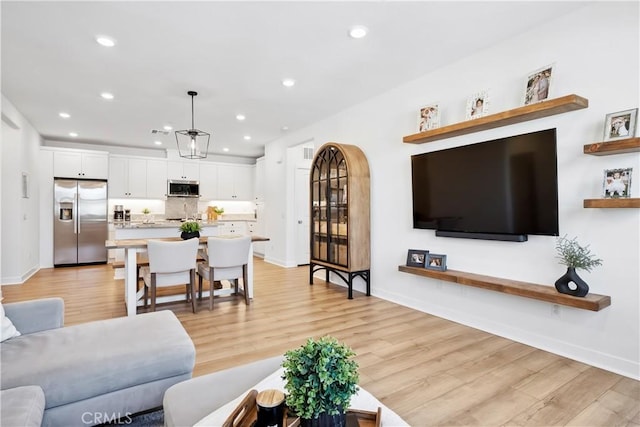 1101 Lasso Way Unit 303, Rancho Mission Viejo, CA 92694 - living room with recessed lighting, light wood-type flooring, and baseboards