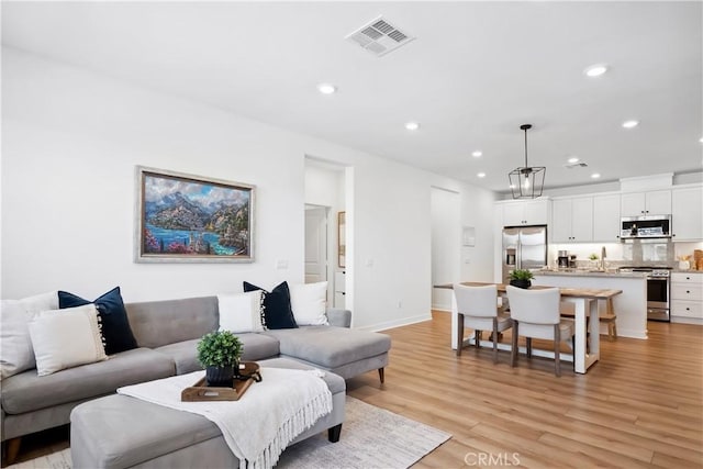 1101 Lasso Way Unit 303, Rancho Mission Viejo, CA 92694 - living room with recessed lighting, light wood finished floors, and baseboards