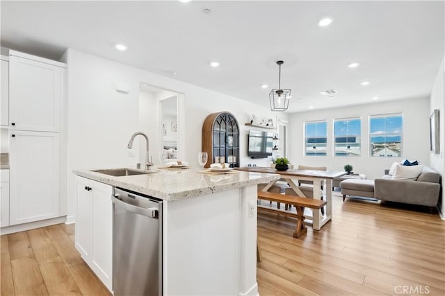 1101 Lasso Way Unit 303, Rancho Mission Viejo, CA 92694 - kitchen featuring dishwasher, a sink, light wood-style floors, white cabinets, and open floor plan