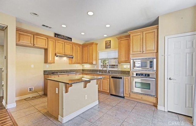 28229 Shirley Ln, Saugus, CA 91350 - kitchen featuring appliances with stainless steel finishes, a kitchen island, a sink, a kitchen breakfast bar, and dark stone counters