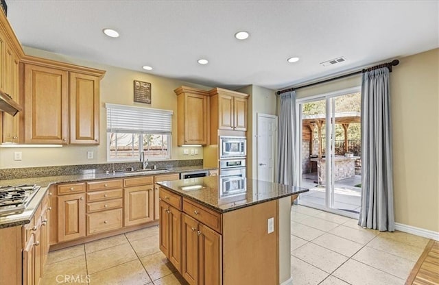 28229 Shirley Ln, Saugus, CA 91350 - kitchen with appliances with stainless steel finishes, a sink, light tile patterned floors, dark stone counters, and recessed lighting