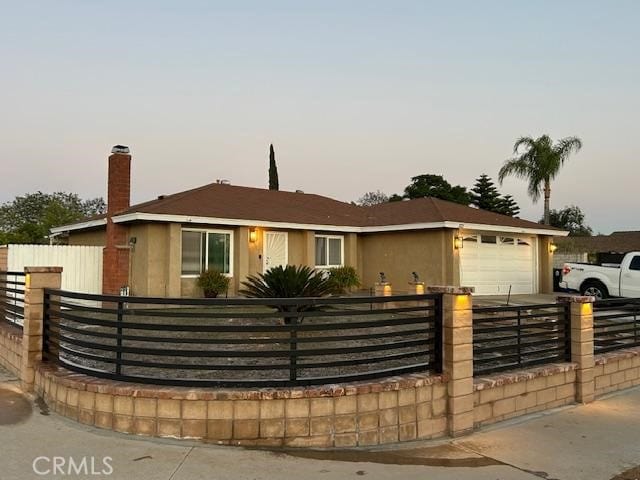 321 N Brampton Ave, Rialto, CA 92376 - ranch-style home with a fenced front yard, a garage, and a chimney