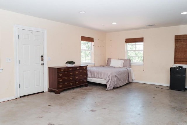 13965 Woods Valley Rd, Valley Center, CA 92082 - bedroom with finished concrete flooring, multiple windows, freestanding refrigerator, recessed lighting, and baseboards