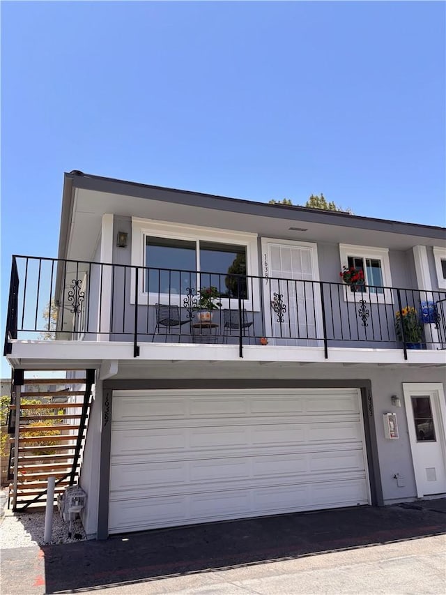 16387 De Anza Cir Unit Ci60, Huntington Beach, CA 92649 - view of front of home with an attached garage and stucco siding