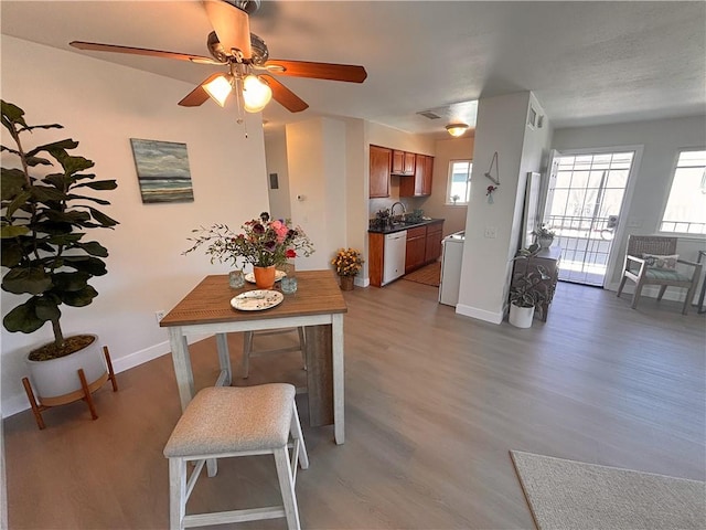 16387 De Anza Cir Unit Ci60, Huntington Beach, CA 92649 - dining space featuring wood finished floors, baseboards, and a ceiling fan