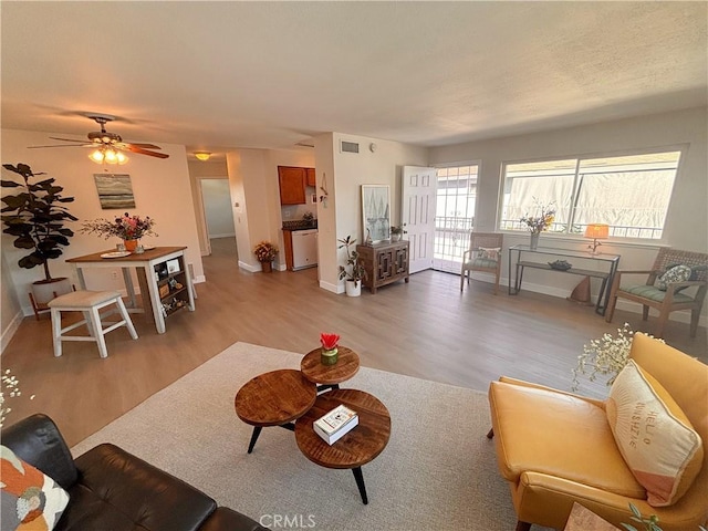 16387 De Anza Cir Unit Ci60, Huntington Beach, CA 92649 - living area with light wood finished floors, baseboards, and ceiling fan