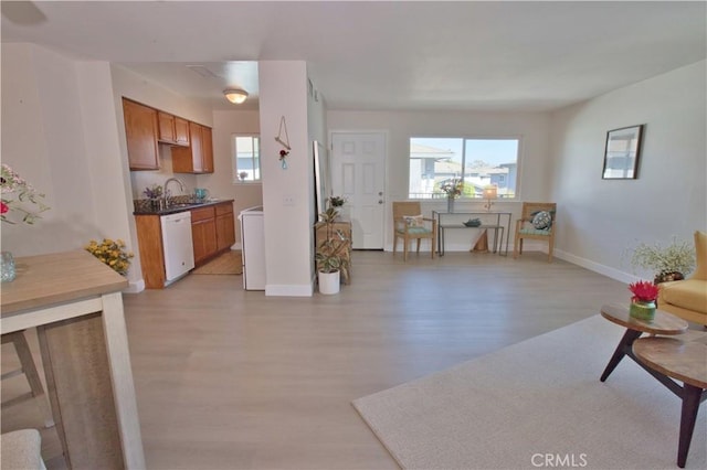 16387 De Anza Cir Unit Ci60, Huntington Beach, CA 92649 - living area featuring light wood-type flooring, baseboards, and washer / clothes dryer
