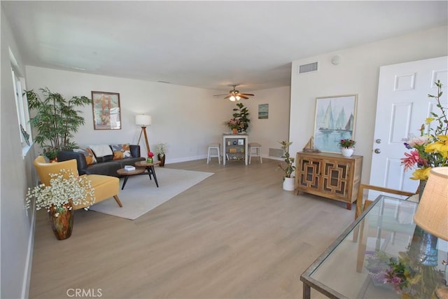 16387 De Anza Cir Unit Ci60, Huntington Beach, CA 92649 - living room with light wood-style flooring, ceiling fan, and baseboards