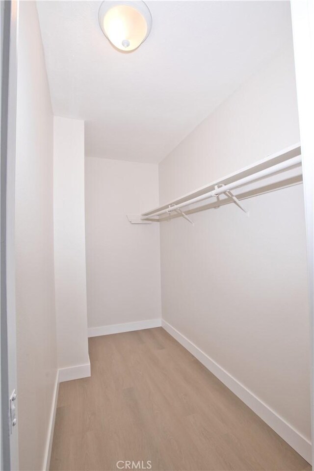 16387 De Anza Cir Unit Ci60, Huntington Beach, CA 92649 - walk in closet with light wood-style floors
