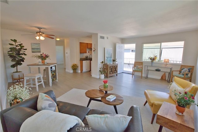 16387 De Anza Cir Unit Ci60, Huntington Beach, CA 92649 - living area with light wood-type flooring, baseboards, and ceiling fan