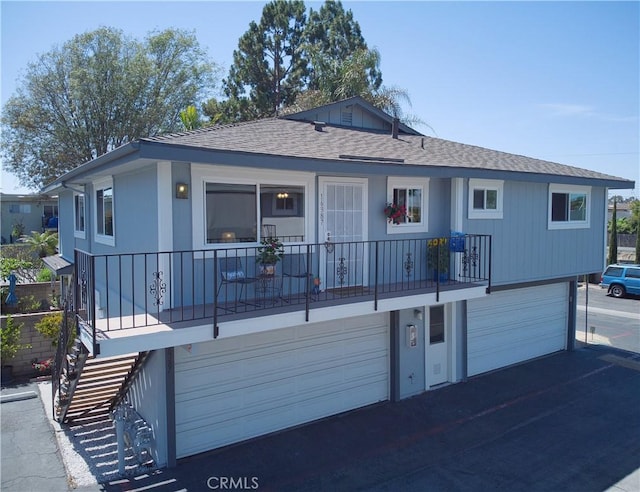 16387 De Anza Cir Unit Ci60, Huntington Beach, CA 92649 - view of front of house featuring a garage, roof with shingles, asphalt driveway, and stairway