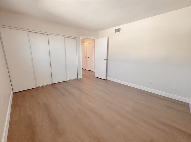16387 De Anza Cir Unit Ci60, Huntington Beach, CA 92649 - unfurnished bedroom with baseboards, a closet, and wood finished floors