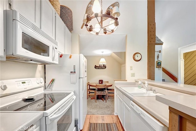 261 Lakeview Blvd Unit 54, Mammoth Lakes, CA 93546 - kitchen with white appliances, a chandelier, light countertops, pendant lighting, and light carpet