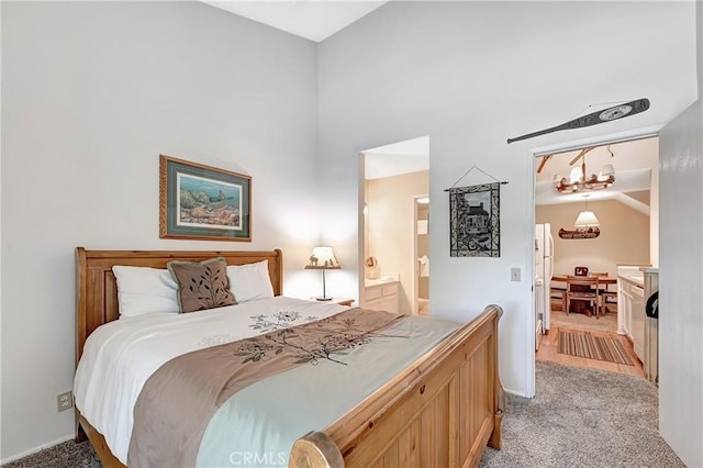 261 Lakeview Blvd Unit 54, Mammoth Lakes, CA 93546 - bedroom with light colored carpet, connected bathroom, freestanding refrigerator, and a towering ceiling