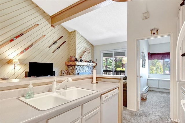 261 Lakeview Blvd Unit 54, Mammoth Lakes, CA 93546 - kitchen with white dishwasher, healthy amount of natural light, light carpet, white cabinets, and wood walls
