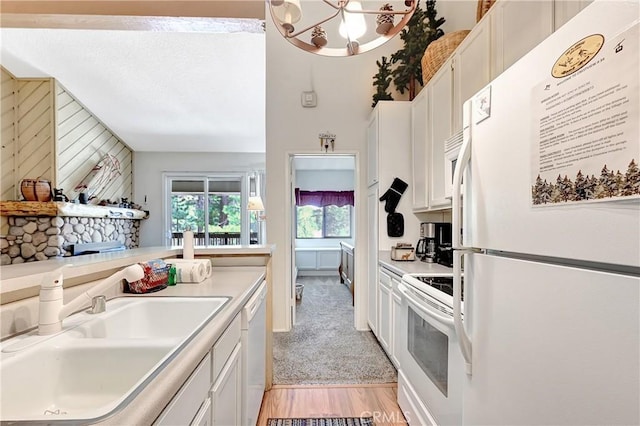 261 Lakeview Blvd Unit 54, Mammoth Lakes, CA 93546 - kitchen featuring white appliances, white cabinets, light countertops, wood walls, and light wood finished floors