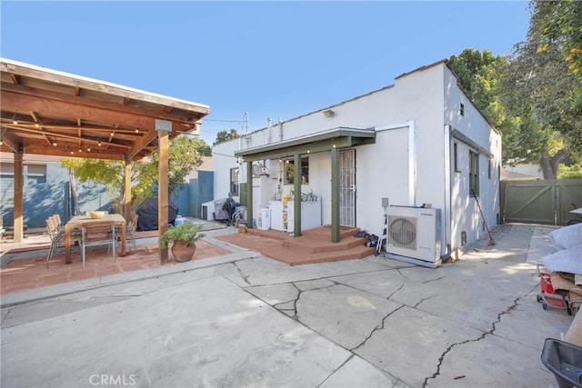 225 E 56th St, Long Beach, CA 90805 - back of house with a patio area, a gate, and stucco siding