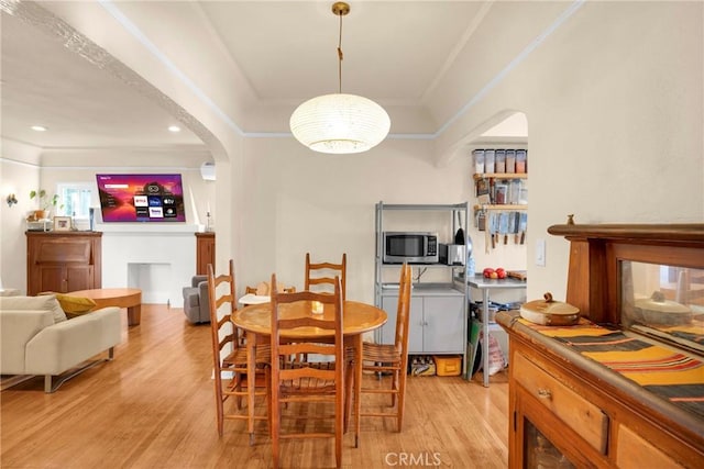 225 E 56th St, Long Beach, CA 90805 - dining area with arched walkways, light wood finished floors, recessed lighting, and a multi sided fireplace