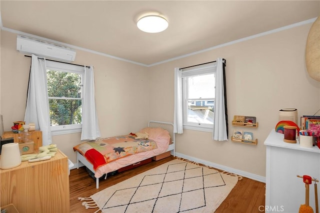 225 E 56th St, Long Beach, CA 90805 - bedroom with a wall unit AC, wood finished floors, and crown molding